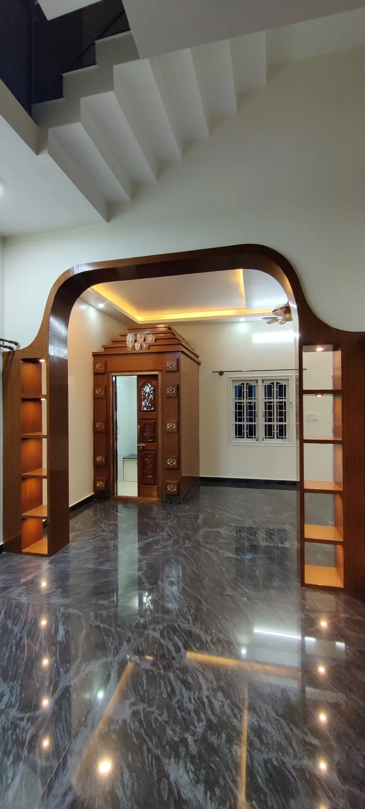 Sculpted wooden arched portal framing staircase