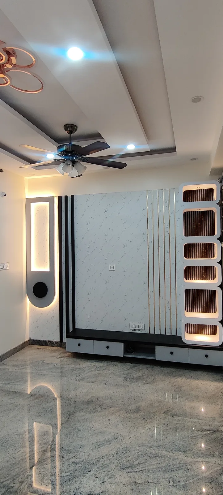 Entertainment wall with fluted dark wood louvers